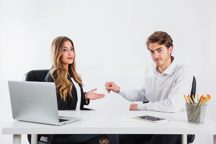 Two professionals sitting at a desk having a business appointment discussion