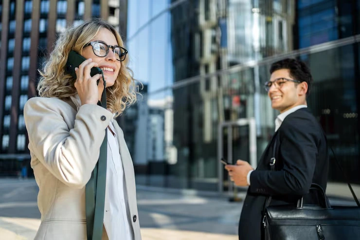Two Confident Business Professionals Making Cold Calls Outside A Modern Vancouver Office Building
